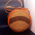 Sac rond en sisal et cuir porté en bandoulière